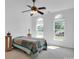 Well-lit bedroom featuring a bed with a colorful quilt and two arched windows at 4028 Garden Oak Dr, Indian Trail, NC 28079