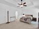 Bright main bedroom offers a ceiling fan and a view of the backyard at 4028 Garden Oak Dr, Indian Trail, NC 28079
