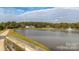 Scenic view of a community pond with a fountain and lush greenery, offering a tranquil and picturesque setting at 4028 Garden Oak Dr, Indian Trail, NC 28079
