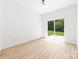 Bright bedroom with sliding glass door and light wood flooring at 413 Jose St, Shelby, NC 28150
