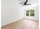 This bedroom has a ceiling fan and a large window, and light-colored wood-look flooring at 413 Jose St, Shelby, NC 28150