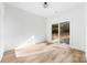 Bright bedroom features wood-look floors and access to outdoor patio via sliding glass doors at 413 Jose St, Shelby, NC 28150