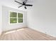 This bedroom has a ceiling fan and a large window, and light-colored wood-look flooring at 413 Jose St, Shelby, NC 28150