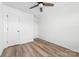 This bedroom offers neutral walls, plank flooring, ceiling fan, and closet storage at 413 Jose St, Shelby, NC 28150