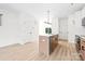 Bright kitchen featuring an island with stainless steel dishwasher, and light wood flooring at 413 Jose St, Shelby, NC 28150
