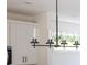 Modern kitchen island lighting fixture with four clear glass cylinders and black hardware at 413 Jose St, Shelby, NC 28150