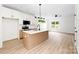 Bright kitchen featuring an island, stainless steel appliances, white cabinets, and light wood flooring at 413 Jose St, Shelby, NC 28150