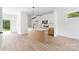 Bright kitchen featuring an island, stainless steel appliances, white cabinets, and light wood flooring at 413 Jose St, Shelby, NC 28150