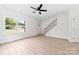 Open-concept living area with wood-look floors, lots of natural light, and staircase at 413 Jose St, Shelby, NC 28150