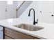 Modern kitchen sink with matte black faucet and white quartz countertop in a home's open kitchen at 413 Jose St, Shelby, NC 28150