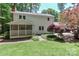 Expansive backyard view showcasing a home with a screened porch and vibrant, mature landscaping at 417 Florence Cir, Statesville, NC 28625