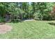 Green backyard with a shed and patio furniture creating a perfect space for relaxing and outdoor enjoyment at 417 Florence Cir, Statesville, NC 28625