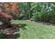 Well-maintained backyard with lush green grass and mature trees, perfect for outdoor enjoyment at 417 Florence Cir, Statesville, NC 28625
