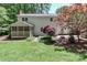 Lush backyard highlighting the home's screened porch, well-manicured lawn, and colorful landscaping at 417 Florence Cir, Statesville, NC 28625