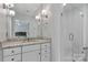 Modern bathroom with white cabinets, granite countertop, glass shower, and stylish lighting at 417 Florence Cir, Statesville, NC 28625