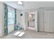 Carpeted bedroom featuring ensuite bathroom, white trim, ceiling fan, and natural light at 417 Florence Cir, Statesville, NC 28625