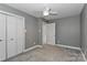 Neutral bedroom with a ceiling fan, closet, and light gray walls providing a calming, cozy space at 417 Florence Cir, Statesville, NC 28625