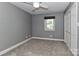 Simple bedroom with neutral carpet, gray walls, a window with a shade, and a closet at 417 Florence Cir, Statesville, NC 28625