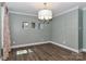 Dining room with hardwood floors, modern lighting fixture, and neutral walls with ample space for entertaining at 417 Florence Cir, Statesville, NC 28625