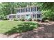 Charming two-story home with a manicured lawn and a lovely blue front door and mature trees at 417 Florence Cir, Statesville, NC 28625