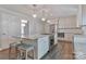 Eat-in kitchen featuring a large center island with cooktop, barstool seating, and stainless appliances at 417 Florence Cir, Statesville, NC 28625