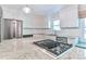 Updated kitchen with stainless appliances, granite island with cooktop, subway tile, and window seat at 417 Florence Cir, Statesville, NC 28625