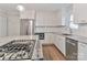Bright kitchen boasts stainless appliances, gas cooktop on granite island, and white cabinetry at 417 Florence Cir, Statesville, NC 28625