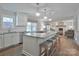 Open-concept kitchen with central island and barstool seating flows into a living area at 417 Florence Cir, Statesville, NC 28625