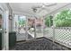 Cozy screened porch features blue rug and a view of the lush backyard landscaping at 417 Florence Cir, Statesville, NC 28625