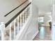 Elegant staircase with carpeted steps, dark handrail, and white spindles, providing a classic touch to the home's interior at 417 Florence Cir, Statesville, NC 28625