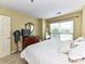 Bright bedroom with a window, neutral decor, and a dresser at 517 N Graham St # 3E, Charlotte, NC 28202