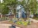 Beautiful blue and brick condo building with manicured flowerbeds and a well-maintained exterior at 517 N Graham St # 3E, Charlotte, NC 28202