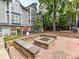 Cozy outdoor fire pit area with stone benches, perfect for gatherings and relaxation in a communal space at 517 N Graham St # 3E, Charlotte, NC 28202