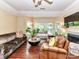 Cozy living room featuring hardwood floors, a fireplace, and large windows at 517 N Graham St # 3E, Charlotte, NC 28202