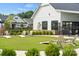 A community lawn area with cornhole boards and Adirondack chairs is near the community building at 527 Sunharvest Ln, Indian Trail, NC 28079