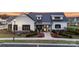 Charming exterior of a white farmhouse-style home with a black roof, lush landscaping, and inviting entrance at 527 Sunharvest Ln, Indian Trail, NC 28079