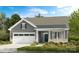 Charming one-story home with a two-car garage, well-manicured lawn, and classic architectural details at 527 Sunharvest Ln, Indian Trail, NC 28079
