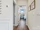 Hallway with hardwood floors leading to a bedroom with blue accents and stylish decor at 527 Sunharvest Ln, Indian Trail, NC 28079
