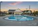 Sparkling community pool and clubhouse with plenty of seating for relaxing by the water at 527 Sunharvest Ln, Indian Trail, NC 28079