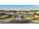 Street view of the new Esplanade community lined with beautiful single-Gathering homes and green spaces at 527 Sunharvest Ln, Indian Trail, NC 28079