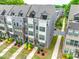 Aerial shot of townhomes, green space, and manicured lawns with trees and colorful landscaping at 556 Billingsley Rd, Charlotte, NC 28211