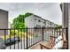 Balcony view of adjacent townhomes in the community from a bench with pillows at 556 Billingsley Rd, Charlotte, NC 28211