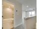 Hallway view of a bathroom with a tiled tub and shower, plus a sliding glass door to an outdoor deck at 556 Billingsley Rd, Charlotte, NC 28211