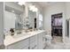 Elegant bathroom features double sinks, white cabinetry, walk-in closet and modern fixtures at 556 Billingsley Rd, Charlotte, NC 28211
