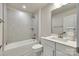 Bathroom boasts tiled shower, neutral wall color, white cabinet, and decorative towel racks at 556 Billingsley Rd, Charlotte, NC 28211