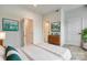 Bright bedroom with wood dresser, modern art and decor, plus multiple doorways and white painted trim at 556 Billingsley Rd, Charlotte, NC 28211