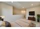 Bedroom area with neutral color scheme, recessed lighting, carpet, and adjacent sitting area with TV at 556 Billingsley Rd, Charlotte, NC 28211