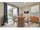Bright dining area with sliding glass doors to balcony and modern decor and beautiful hardwood flooring at 556 Billingsley Rd, Charlotte, NC 28211
