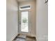 Bright entryway with a door featuring window blinds, and a wood-look floor at 556 Billingsley Rd, Charlotte, NC 28211