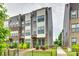 Modern townhome showcasing a brick and siding exterior with a small fenced front yard at 556 Billingsley Rd, Charlotte, NC 28211